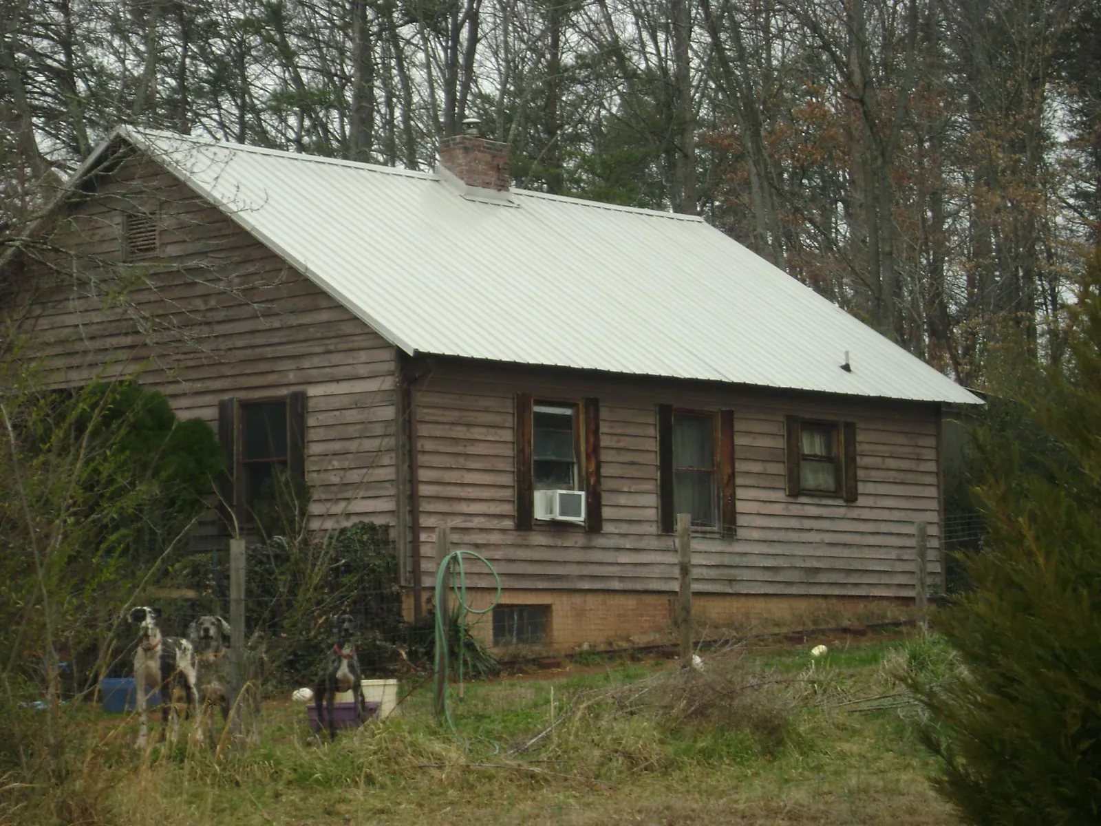 White metal roof on an old wood sided farmhouse, from a Metal Roof Installation job in Barton
